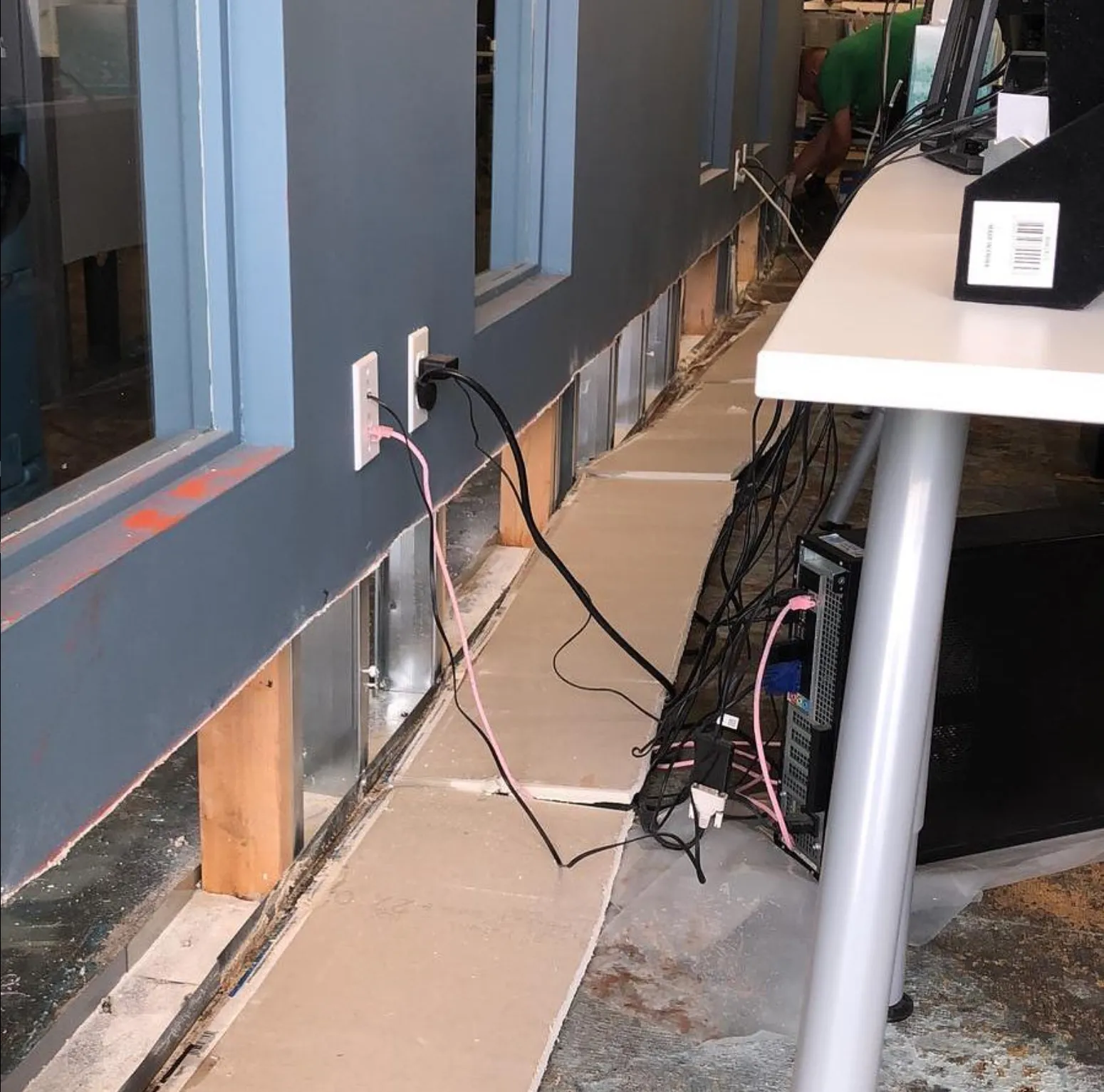 Office wall cutaway showing damage, mid-restoration