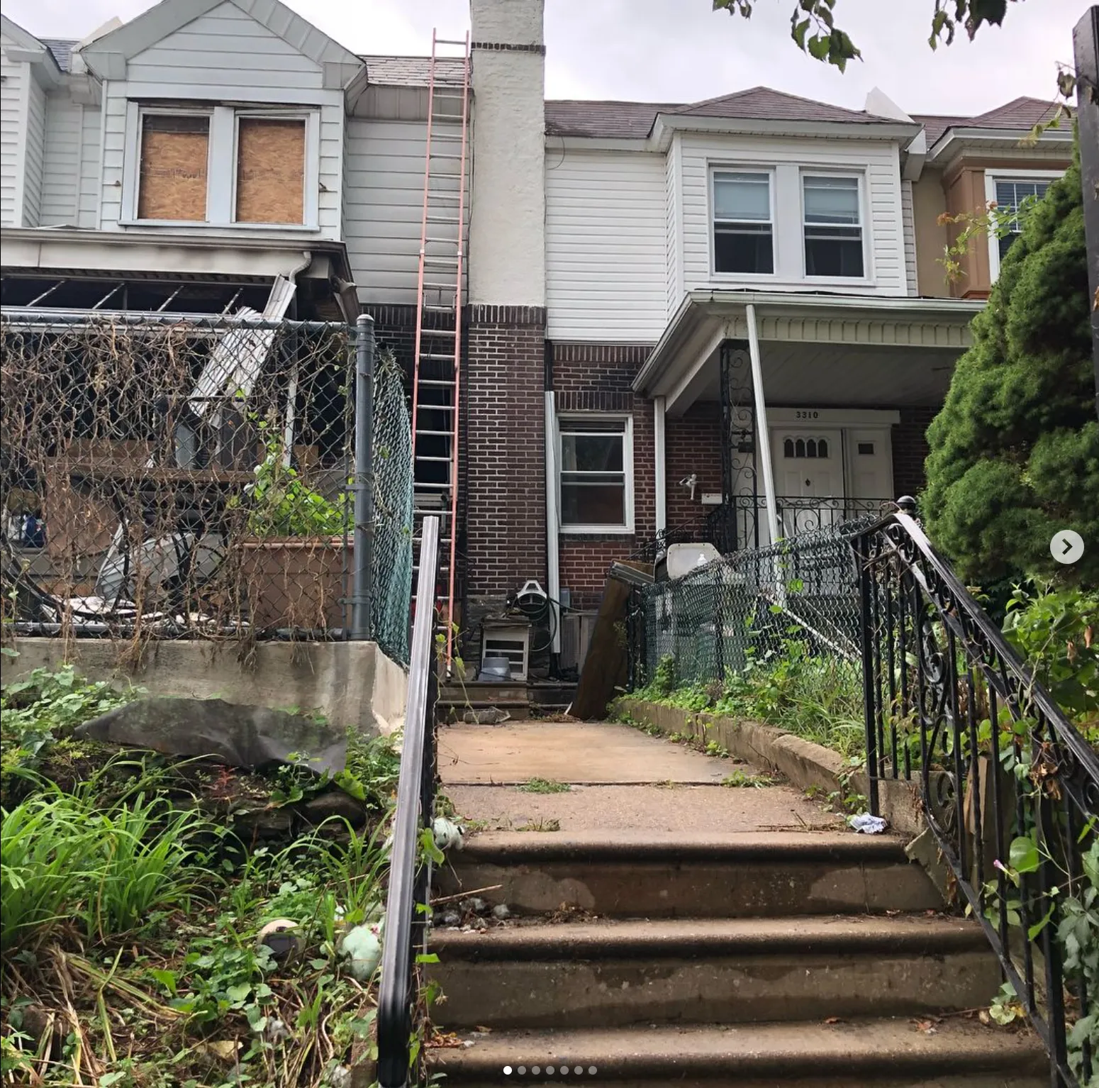 A rowhouse boarded up post-fire by Priority Restoration