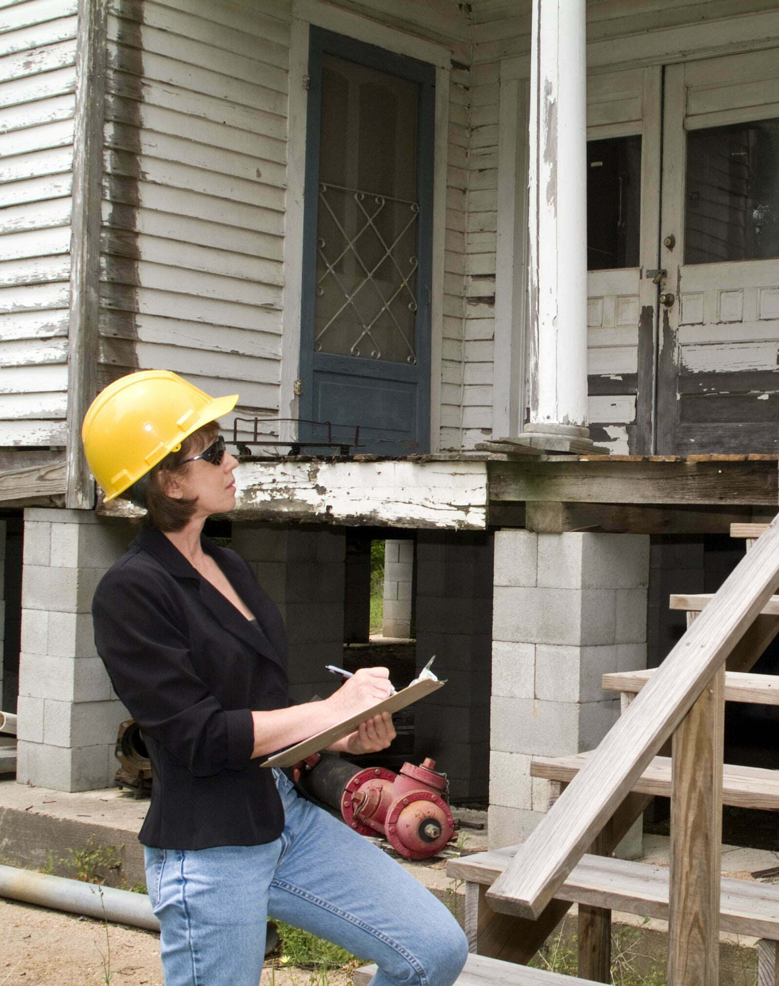 Priority Restoration inspector evaluating structural damage on property